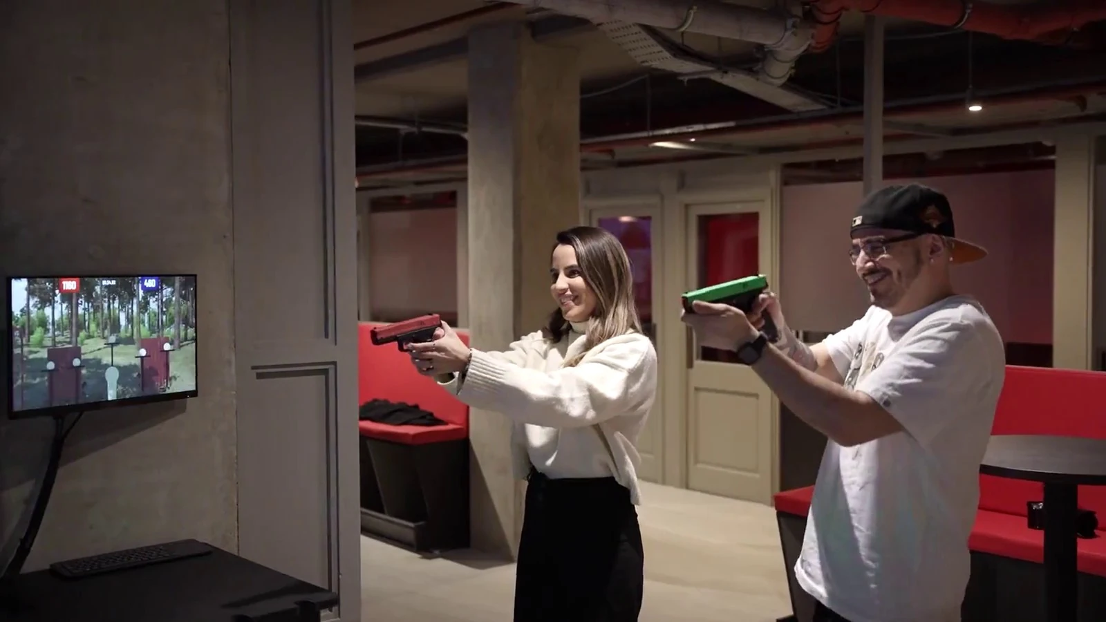 Two players trying target shooting together at Aldgate