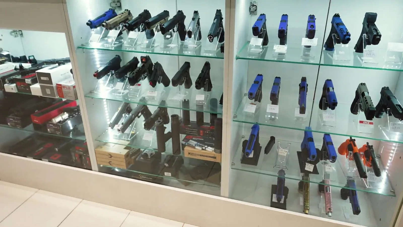 A glass cabinet of airsoft equipment at Camden