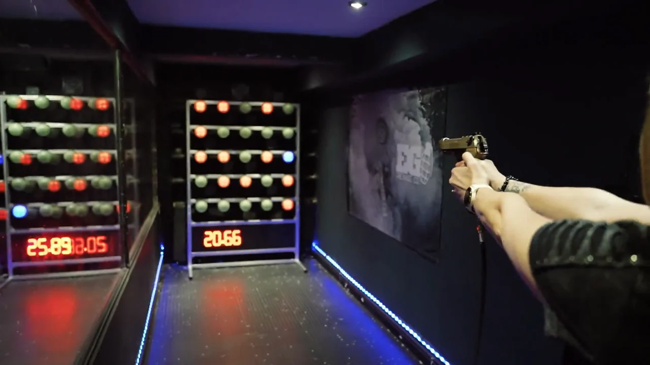 A customer taking aim in Camden’s blue-lit lane